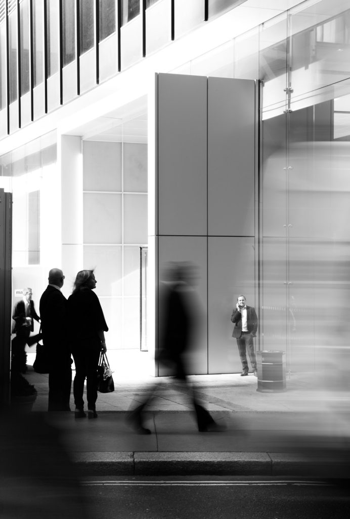 People walking towards a professional business building